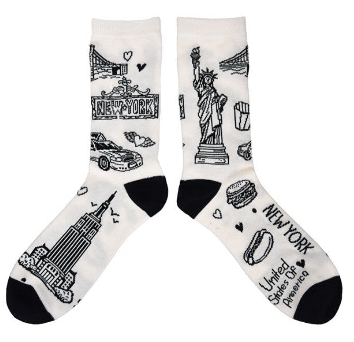 Pair of socks with black ink illustrations of NYC icons on a white background.