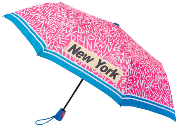 Bright pink and covered edge to edge with bold white “NEW YORK” lettering, this umbrella subtly hides iconic city landmarks within the letter shapes, revealed on closer look. Four “NEW YORK” words in black block lettering appear on alternating canopy panels, each set inside a pale yellow box with a fine white border. A blue and white rim, blue finial and handle, and a one button open complete the design.