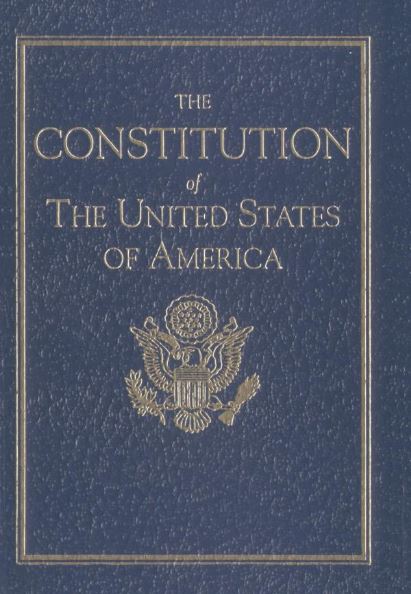 The Constitution of the United States has a textured, easy-to-recognize design. Its smooth, grained blue cover feels different from the paper pages inside. The cover features raised embossing, including the Great Seal of the United States and decorative borders in gold. The title, “Constitution of the United States,” appears in gold lettering. It is a small, pocket-sized book (about 4.25 by 6.75 inches).