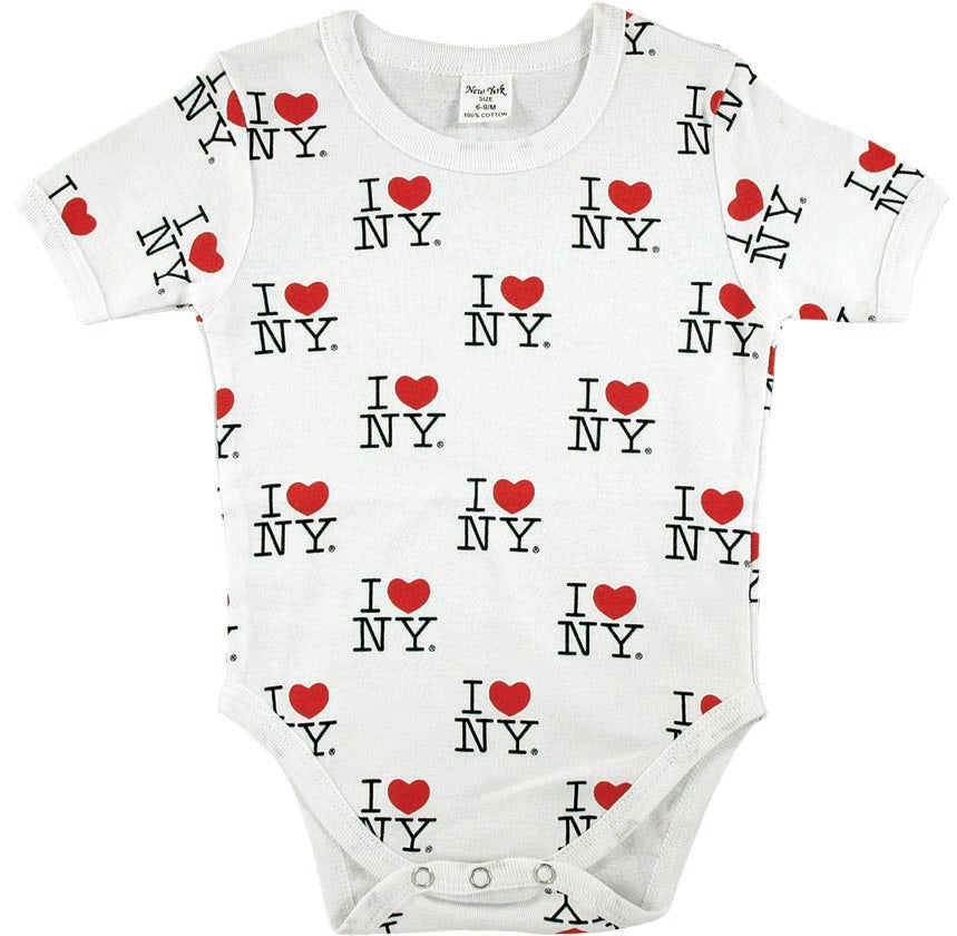 A baby onesie made of soft white fabric is shown laid flat. It’s covered in an all‑over print featuring the classic “I ❤ NY” design. The lettering is bold black, and each heart is a bright red, repeating in a neat pattern across the entire garment — front, back, and sleeves. The high‑contrast red, black, and white colors make the design pop visually. The onesie has short sleeves, three snaps at the bottom, and a simple, clean shape typical of infant clothing.