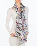 A white scarf with train symbols in various colors. Symbols include: metro card, light rail, subway signs, etc.
