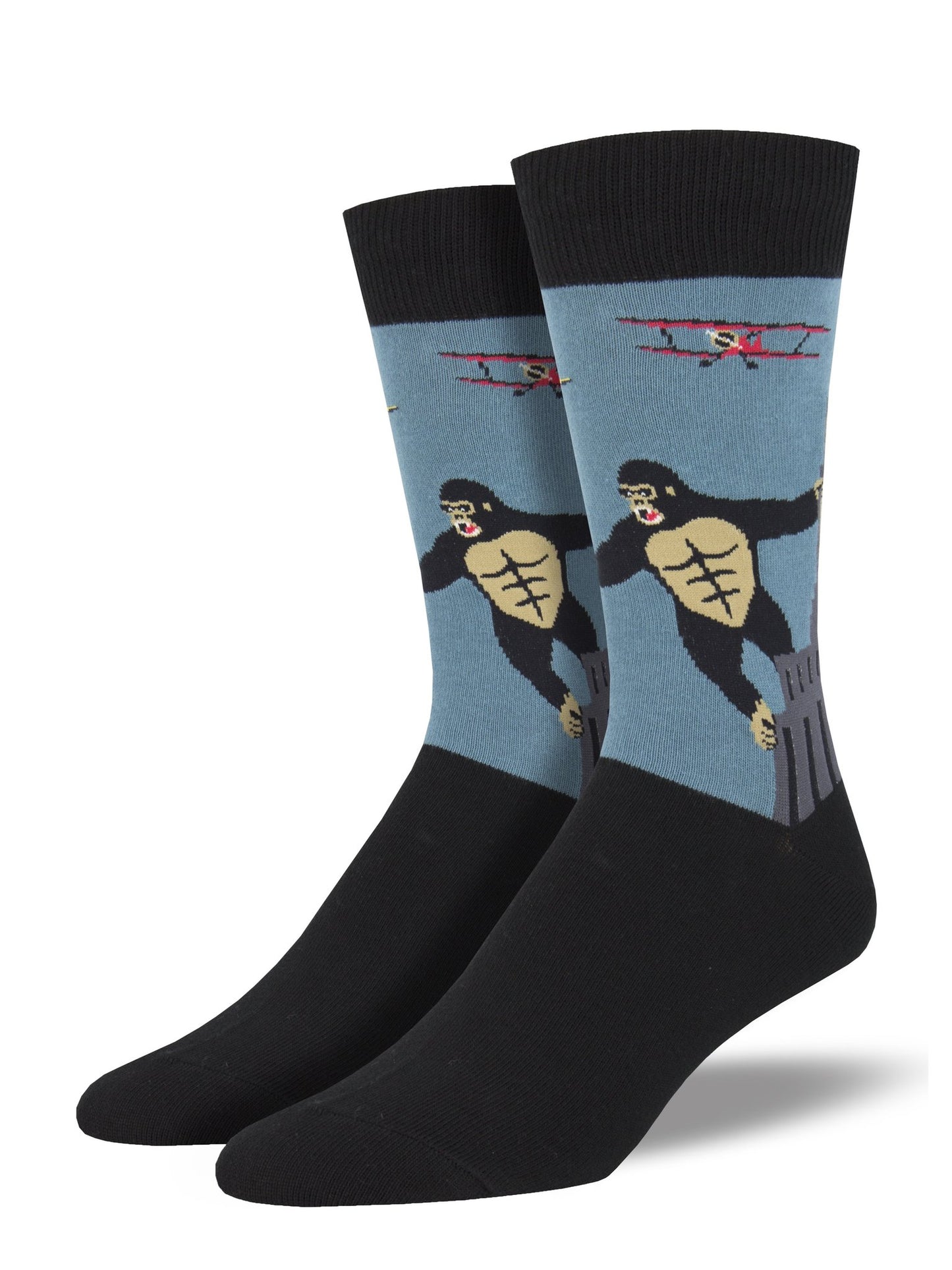 These are crew‑style socks featuring a classic New York City movie scene. The design shows King Kong, a black‑and‑white ape, with his arms outstretched as he clings to the gray Empire State Building. A small red bi‑plane appears nearby as if attacking, set against a light blue background.
The top band and foot of the socks are black. Made from a soft cotton‑nylon blend, the socks offer gentle stretch and detailed imagery, making them a fun and memorable New York City souvenir.
Sock size 10-13 fits U.S. men