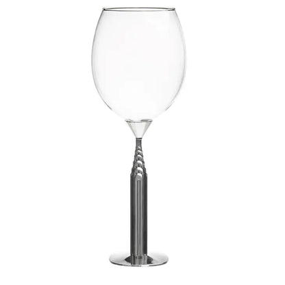 Clear wine glass with a metallic base on a white background