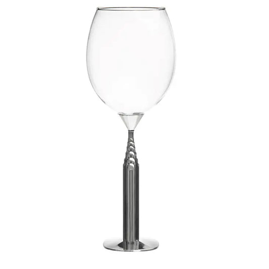 Clear wine glass with a metallic base on a white background
