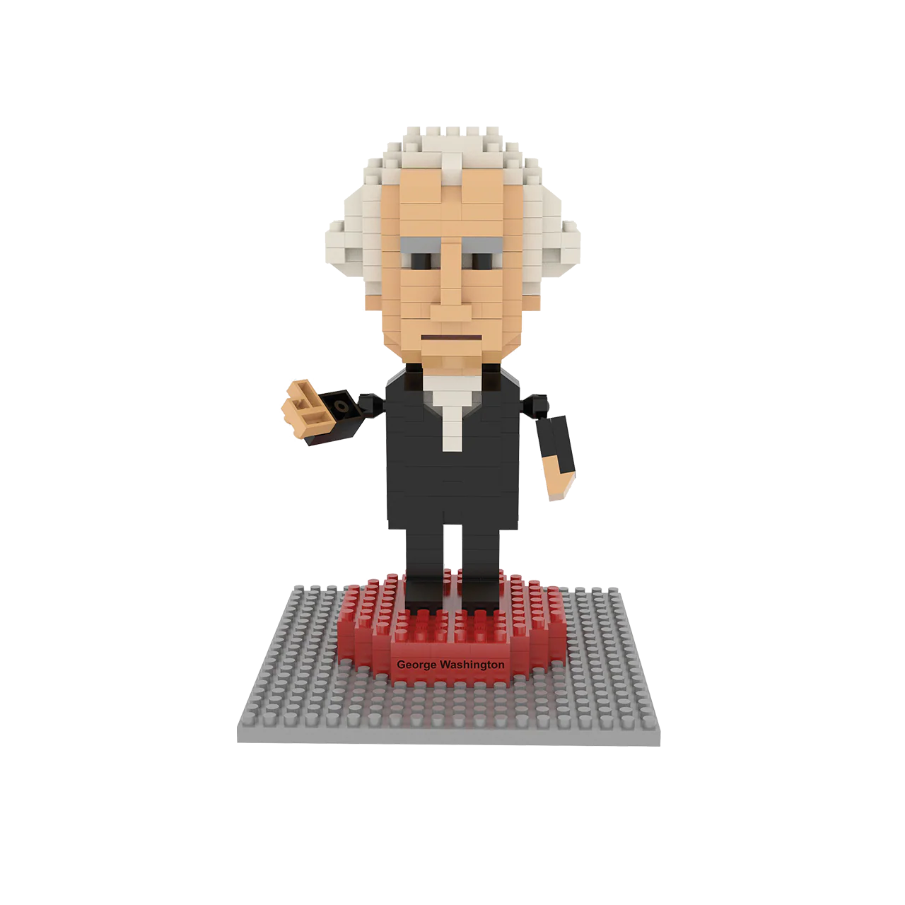 A toy figure of George Washington stands upright on a small base labeled with his name, set against a plain white background. The figure is about 4.5 inches tall and made from tiny interlocking blocks, wearing a long, black 18th-century coat with simple, calm facial features.