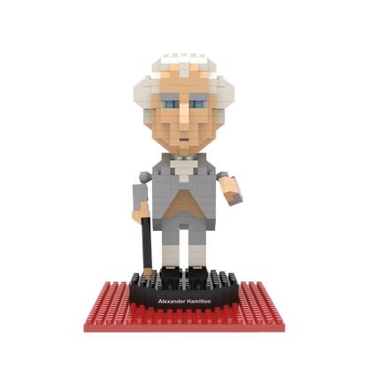 The image shows a rendering of the assembled mini-block Alexander Hamilton figure, posed on a black base with a red platform beneath it, set against a white background.
