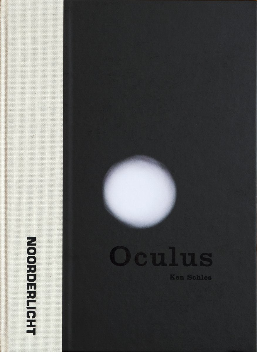 The cover of Oculus by Ken Schles features a stark black-and-white design with a glowing white circle centered against a black background, framed by a narrow beige cloth spine on the left.