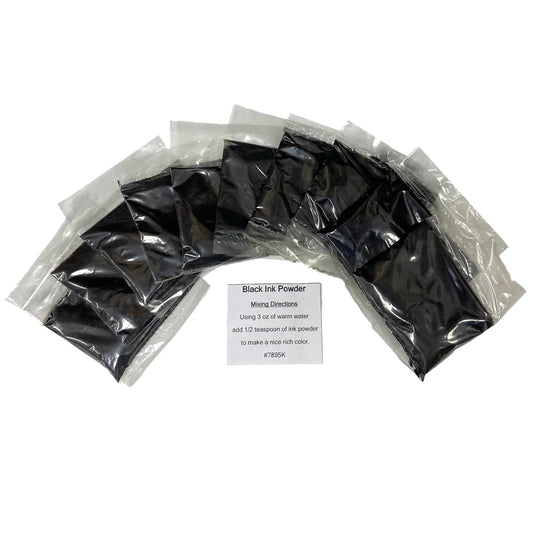 Packets of black ink powder arranged in a semi-circle on a white background with a label in front.