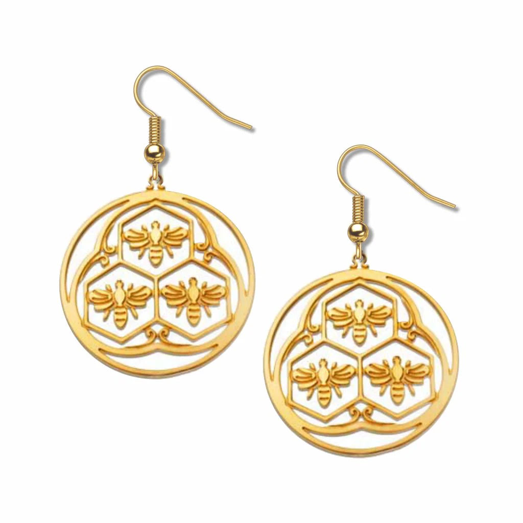 Gold bee and honeycomb patterned earrings on a white background