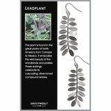 Leaf-shaped earrings on a card with plant information and branding