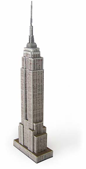 A postcard with the title “Build Your Own New York City Landmark.” The design shows simple, colorful shapes—like rectangles, triangles, and arches—that can be arranged to resemble famous New York City buildings. The layout is playful and inviting, encouraging creativity.