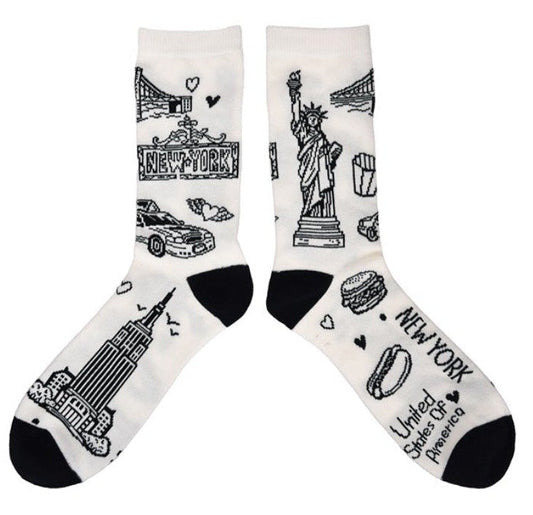 Pair of socks with black ink illustrations of NYC  icons on a white background.