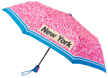 Bright pink and covered edge to edge with bold white “NEW YORK” lettering, this umbrella subtly hides iconic city landmarks within the letter shapes, revealed on closer look. Four “NEW YORK” words in black block lettering appear on alternating canopy panels, each set inside a pale yellow box with a fine white border. A blue and white rim, blue finial and handle, and a one button open complete the design.