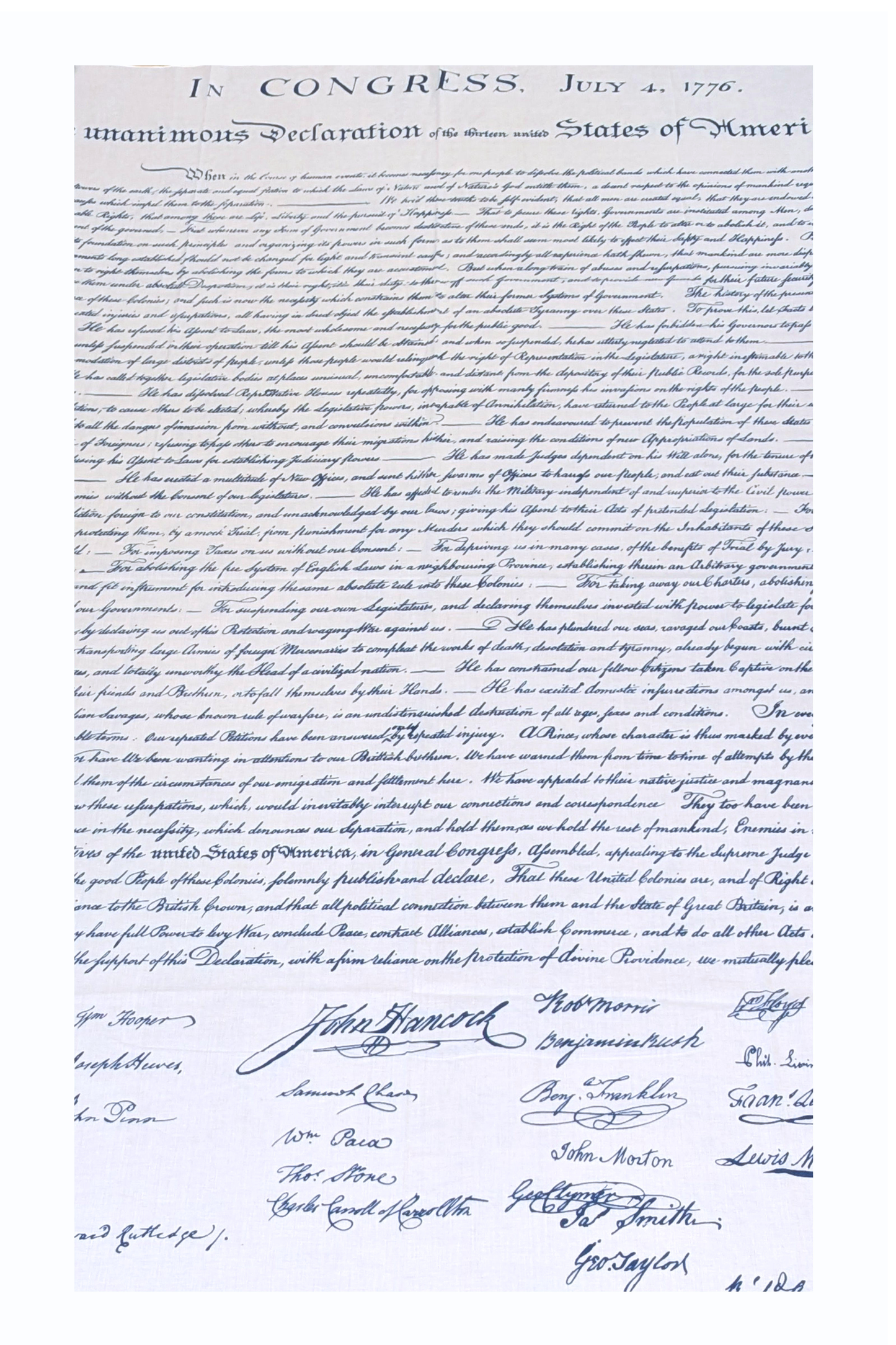 This lightweight rectangular scarf is soft and smooth with a slightly linen‑like texture. It is beige, resembling aged parchment, and printed in black with the opening text of the U.S. Declaration of Independence, including “IN CONGRESS, JULY 4, 1776.” The text appears toward one or both ends, allowing it to be felt lightly through the fabric when draped or wrapped.
