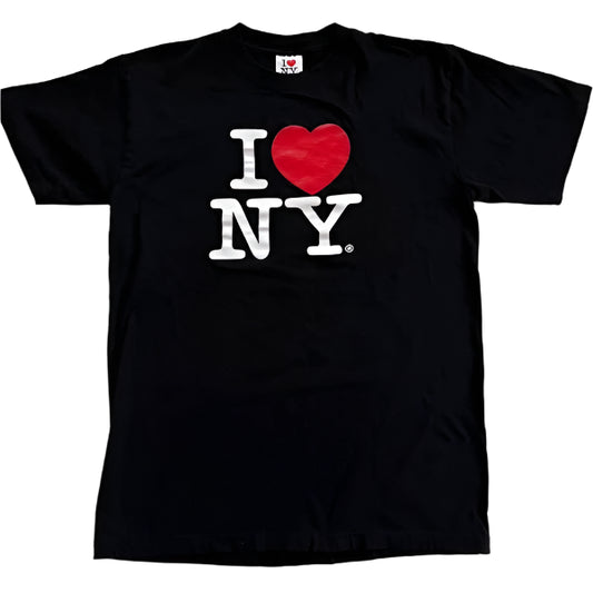 This T‑shirt features the iconic ‘I Heart NY’ design: a bold white letter ‘I,’ a bright red heart, and the letters ‘NY’ in bold white text, all set against a black background.