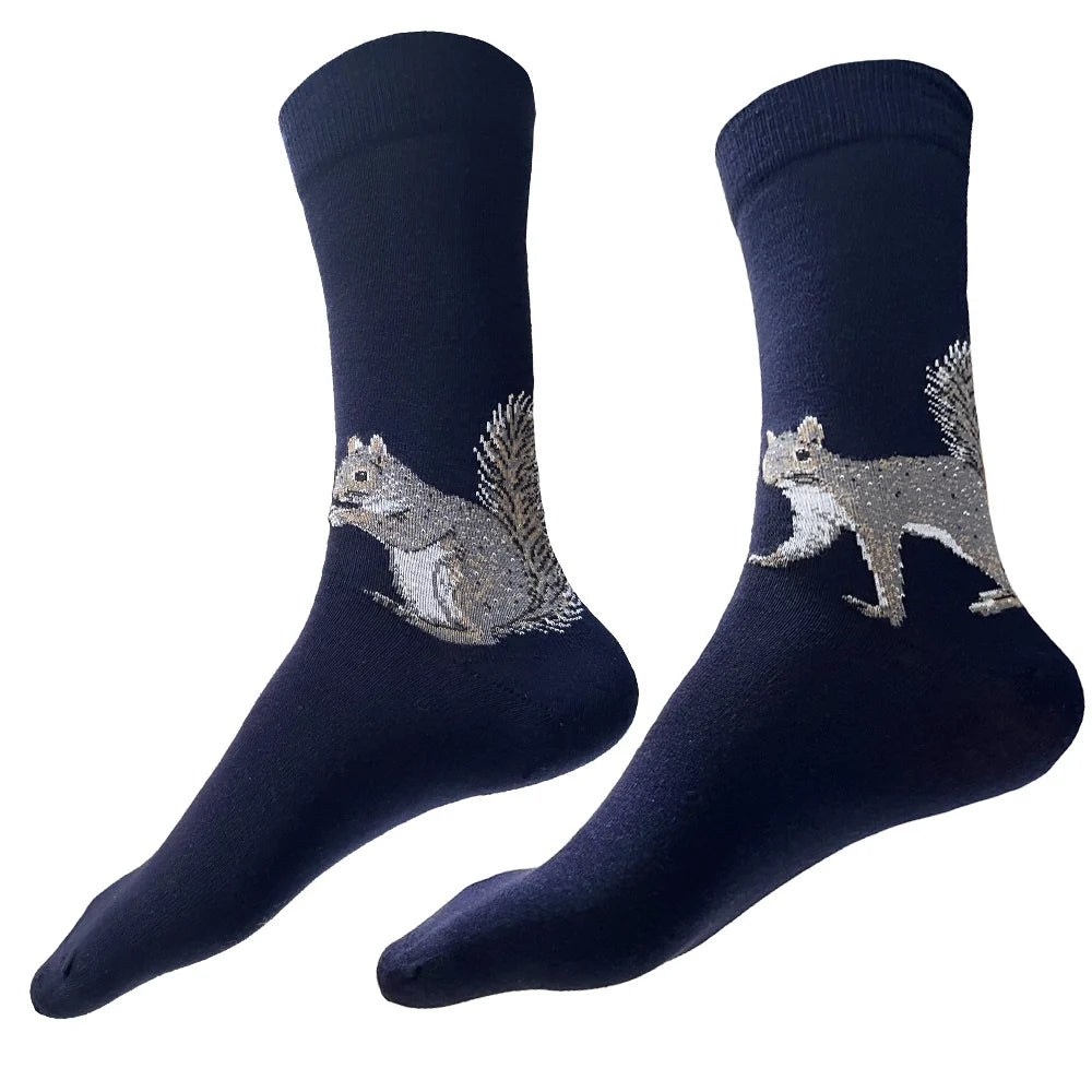 Squirrel Socks shown against a white background. These navy-blue crew socks feature two charming brown squirrels with white underbellies, prominent black eyes, and short rounded ears: one on the left enjoying a nut and the other on the right poised for action. Made from a soft cotton blend, the socks are available in sizes that fit most men and women.