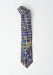 A men's tie with NYC city grid with deep blue buildings and gold streets.