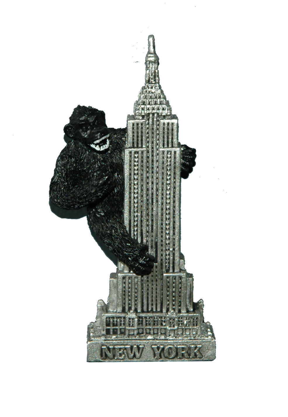 A small souvenir magnet featuring King Kong, the famous movie monster. You can feel a raised, textured design of a large ape gripping the Empire State Building, with the building’s vertical lines clearly defined beneath his hands and feet. The figure is sturdy and slightly three‑dimensional, designed to stand out by touch. It represents a dramatic moment from classic film history and is meant to be fun, bold, and collectible.