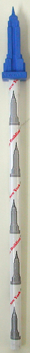 A pencil topped with a small sculpted version of the Empire State Building’s spire. The topper is tall, narrow, and textured with ridges to mimic the building’s iconic crown.