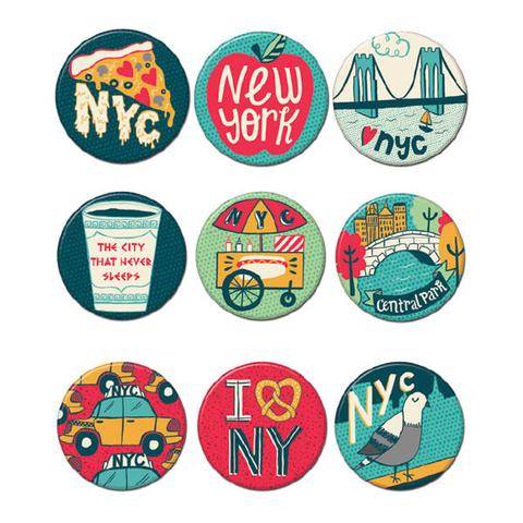 9 small, round NYC colorful pin buttons, each about 1.25 inches wide, with simple raised designs you can feel by touch—like a pizza slice, yellow taxi, pigeon, Brooklyn Bridge with a heart, deli cup, Central Park bridge, pretzel‑shaped heart, food stand, and a red apple reading “New York.” Each pin has a smooth printed front, a metal pin back, and is made from recycled steel and FSC‑certified paper. Sold individually—choose your design.