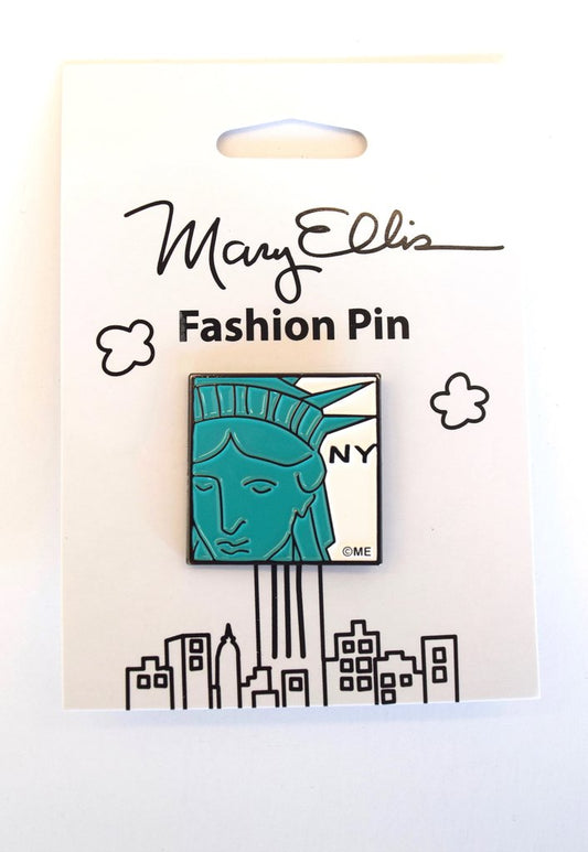 Statue of Liberty:
A simplified, graphic illustration showing a partial view of the face and crown, rendered in bright green with clean, bold outlines and minimal interior detail. The image is immediately recognizable and presented in a flat, iconic style rather than a realistic one. The letters “NY” appear in black to the right of the illustration, set against a white background. The item is shown in its clean illustrated white packaging.

