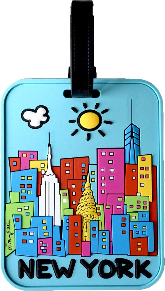 The luggage tag is a durable 3D PVC design featuring a cheerful, cartoon‑style New York City skyline set against a bright blue background. Rendered in vivid pinks, yellows, lime green, blue, red, and orange, the raised, tactile skyline is topped with a radiant yellow sun accented by black rays and a white puffy cloud outlined in black. Along the bottom, NEW YORK appears in large, rounded block lettering. A black flat belt fastener attaches through a belt‑loop hole at the top of the tag.