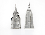 Whimsical, detailed silver-toned salt and pepper shakers that depict The Empire State Building and The Chrysler Building.