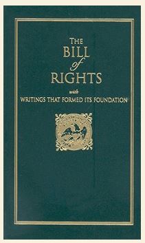 The Bill of Rights has a durable, leather‑like cover in rich green. Gold lettering and a double‑line border are pressed into the surface, creating a sunken design you can feel with your fingers. It is small, pocket‑sized, and built to be sturdy and easy to handle.