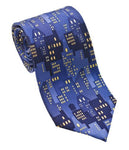 A blue silk tie with an allover print of buildings at night with the lights on.