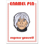 A one inch enamel pin in the shape of an illustrated portrait of Andy Warhol.