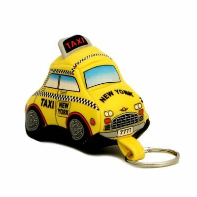A small, yellow, soft taxi keychain made from springy squeeze foam, shaped like a rounded cab with black‑and‑gray wheels and a printed black checker pattern along the sides and the front of the roof. When squeezed, it gently compresses and slowly returns to shape. A roof sign displays “TAXI” in red on a black background. A cloth loop attached to a keyring hangs below the front bumper. “New York” is boldly printed in black on the hood, with “Taxi” and “New York” printed in bold black along the sides.